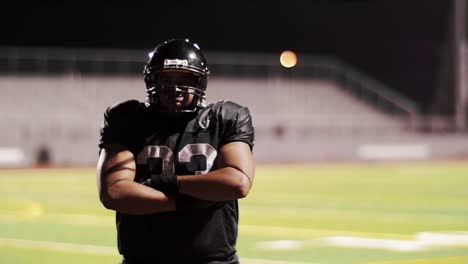 Portrait-of-a-football-player-crossing-his-arms-on-the-field