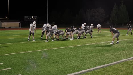 Pan-up-of-a-football-player-being-tackled-after-the-snap