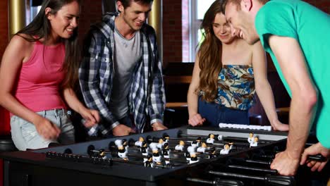 Happy-friends-playing-table-football