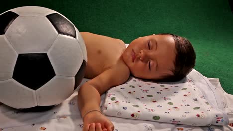 Tired-child-sleeping-with-ball