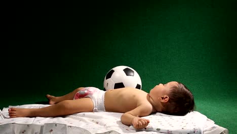 Tired-child-sleeping-with-ball