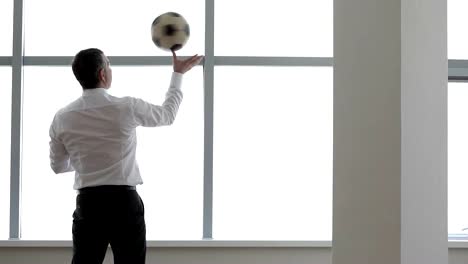 Businessman-Plays-with-a-Football-Ball