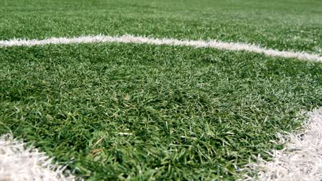 Close-up-of-the-out-of-bounds-line-on-a-turf-football-field