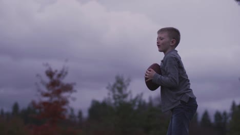 A-young-boy-picks-up-a-dropped-a-ball-and-throws-it-back