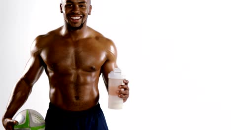 American-football-player-holding-a-water-bottle-and-rugby-ball