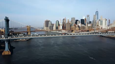 Aerial-view-of-the-skyscrapers-in-downtown-in-New-York,-America.-Manhattan-bridge-going-through-the-East-river