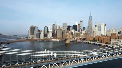 Aerial-view-of-downtown-in-New-York,-America.-Drone-flying-over-Manhattan-bridge-and-under-Brooklyn-bridge,-acceleration