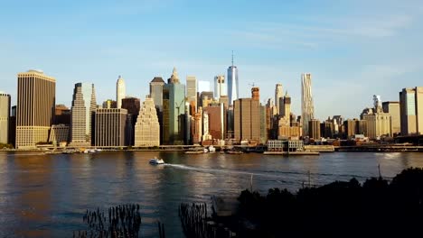 Drone-flying-from-the-Brooklyn,-view-on-Manhattan-in-New-York,-America.-East-river,-Governors-island,-statue-of-liberty