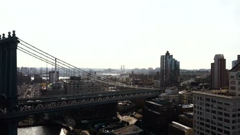 Aerial-view-of-Manhattan-bridge-in-Brooklyn-district.-Drone-flying-over-the-East-river-in-New-York,-America