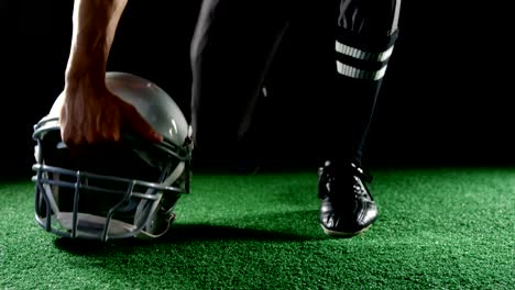American-football-player-resting-his-hands-on-head-gear-4k