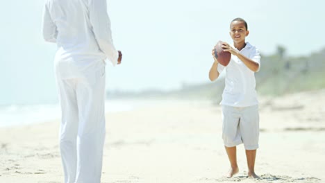 Ethnic-boy-playing-American-football-with-his-father