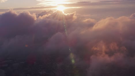 Aerial-view-of-sunrise-over-clouds-with-Manhattan-below.