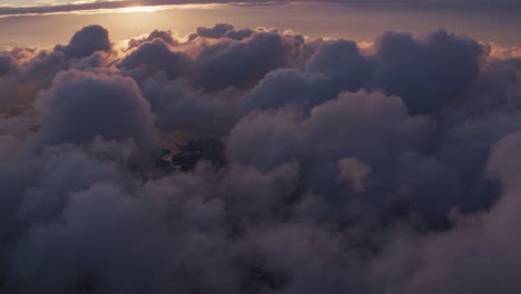 Aerial-view-of-sunrise-over-clouds-with-New-York-City-below.