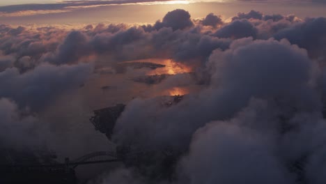 Aerial-view-of-sunrise-over-clouds-with-New-York-City-below.