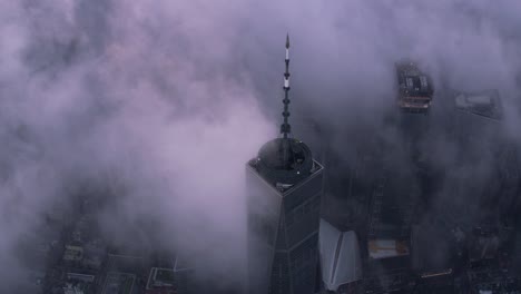 Aerial-view-of-One-World-Trade-Center-building-with-low-clouds-at-sunrise.