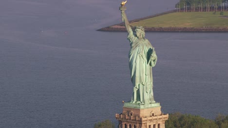 Aerial-view-of-Statue-of-Liberty-at-sunrise,-Manhattan.