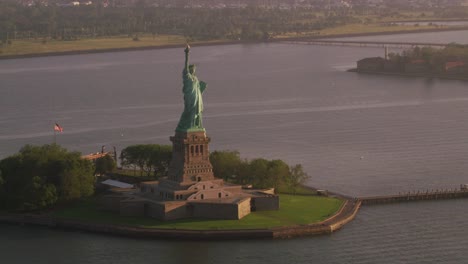 Aerial-view-of-Statue-of-Liberty-at-sunrise,-Manhattan.