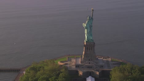 Aerial-view-of-Statue-of-Liberty-at-sunrise,-Manhattan.