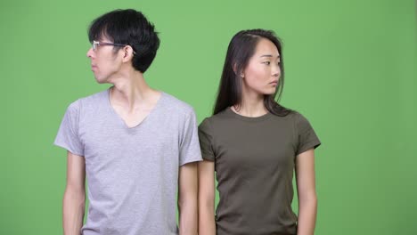 Young-Asian-couple-looking-away-together