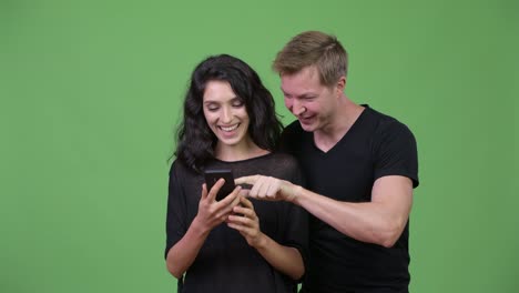 Young-couple-using-phone-together