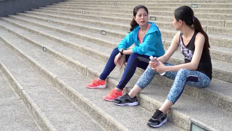 two-girl-friends-jogger-having-conversation