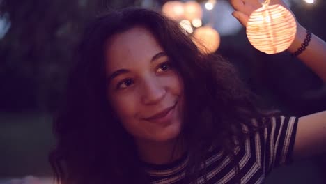 slow-motion-shot-of-young-woman-lighting-sparklers-in-garden