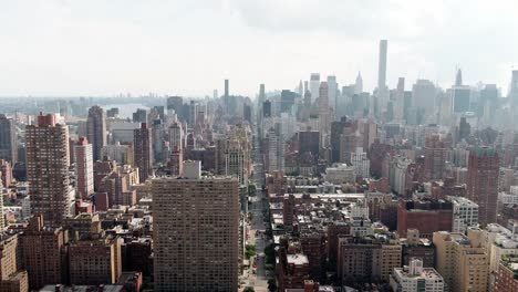 aerial-passing-two-buildings-in-foreground-Manhattan-cityscape-New-York-City