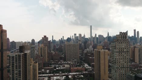 aerial-passing-through-buildings-toward-Empire-State-Building-in-Manhattan-cityscape-New-York-City