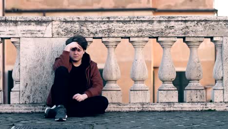 portrait-of-sad-young-man-crying-sitting-on-the-ground-his-friend-comforting-him