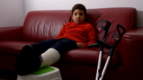 unhappy-child-with-broken-leg-plaster-because-he-can-not-play-with-friends