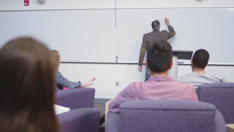 A-professor-begins-class-by-writing-on-the-whiteboard