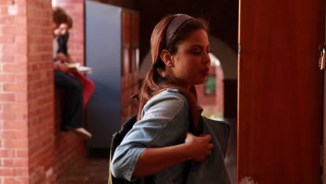 Student-walking-to-her-locker-and-opening-it