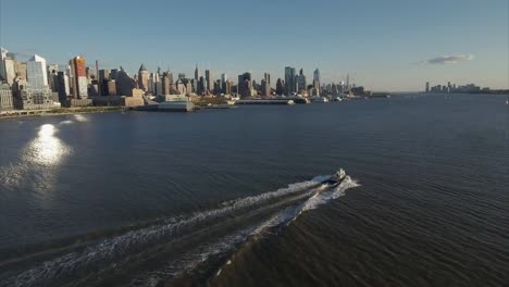 Following-Boat-on-Hudson-River-Viewing-Uptown-Flying-Towards-Midtown-Manhattan