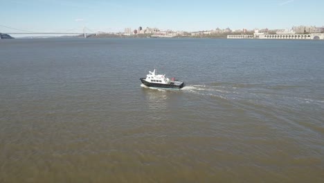 Flying-Towards-Tug-Boat-on-Hudson-River-With-Jersey-In-Shot