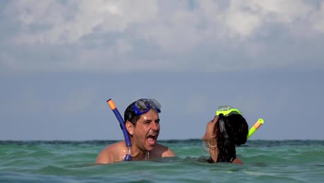 Fun-Couple-Swimming-In-Ocean-On-Vacation