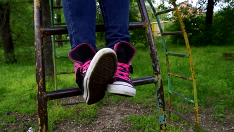 Female-feet-in-sneakers-moving-and-posing-in-spring-park.