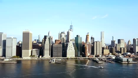 Aerial-view-of-the-Manhattan-downtown-in-New-York,-America.-Water-transport-riding-through-the-East-river