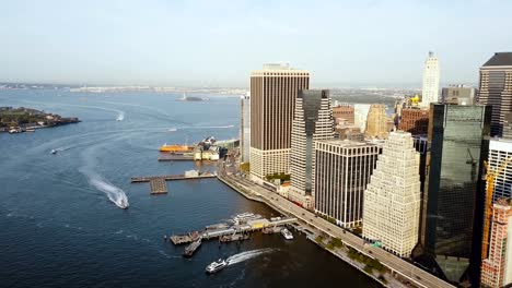 Aerial-view-of-the-Manhattan-in-New-York,-America.-Drone-flying-away-from-the-shore-of-East-river,-business-part-of-city