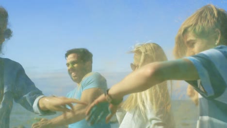 Multi-Ethnic-Group-of-Young-People-Throw-Colorful-Powder-at-Each-other-in-Celebration-of-Holi-Festival.-They-Have-Enormous-Fun-on-this-Clear-Day-by-the-Sea.