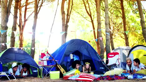 Couples-relaxing-on-tent-at-music-festival-4k