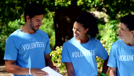 Volunteers-discussing-with-each-other-in-park-4k