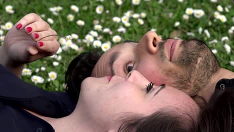 sweet-and-romantic-couple-lying-on-the-grass-chatting