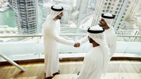 Arab-males-in-national-dress-handshake-greeting-downtown