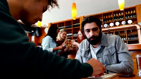 Friends-playing-chess-in-bar-4k