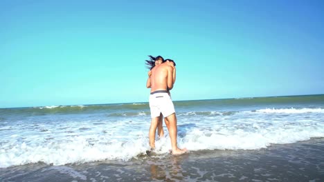 Caucasian-man-and-Hispanic-woman-on-beach-vacation