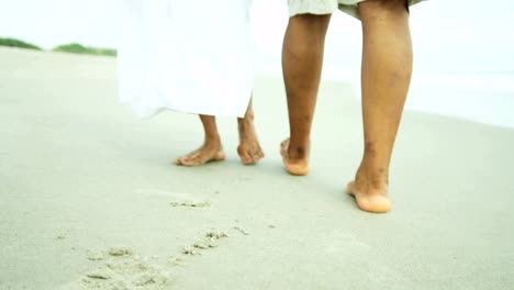 Legs-and-feet-of-ethnic-couple-walking-barefoot