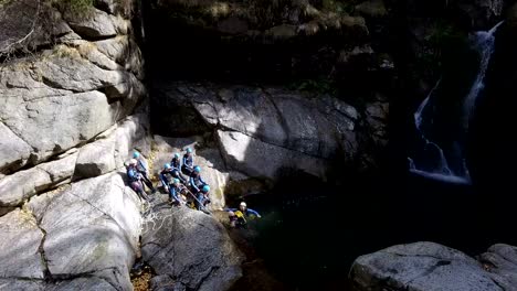 Adventure-Seeking-Rock-Climbers-Swim-Across-a-Waterfall's-Plunge-Pool