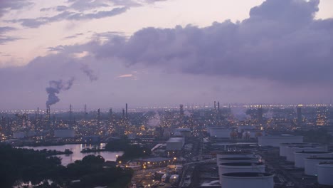 Flying-by-industrial-area-with-oil-refinery-in-early-morning.