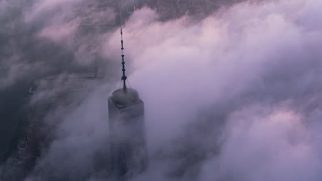 Aerial-view-of-One-World-Trade-Center-building-with-low-clouds-at-sunrise.