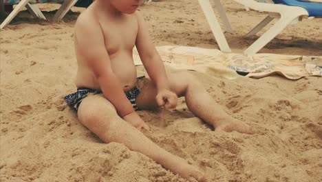 4K-View-Child-Playing-in-Sand-at-Beach-Happy-Caucasian-Little-Girl,-Kid-Having